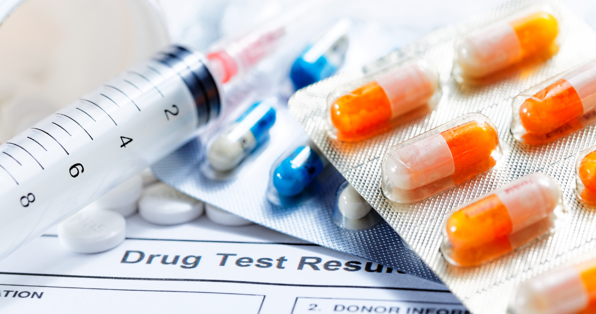 Syringe, capsules and drug test result form representing IND application and submission requirements for investigational medicines.